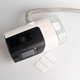 Top view of three disposable Airsense 11 filters by Snugell set besides a CPAP machine