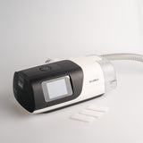 3 out of the 40 ultra fine Airsense 11 filters by Snugell next to a CPAP device