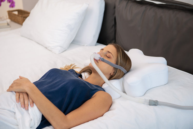Front faced sleeper catching rest on a covered CPAP pillow by Snugell