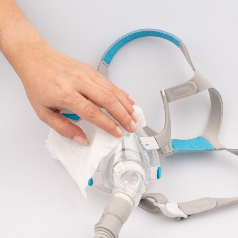 CPAP mask being wiped down with an unscented CPAP mask wipe by Snugell